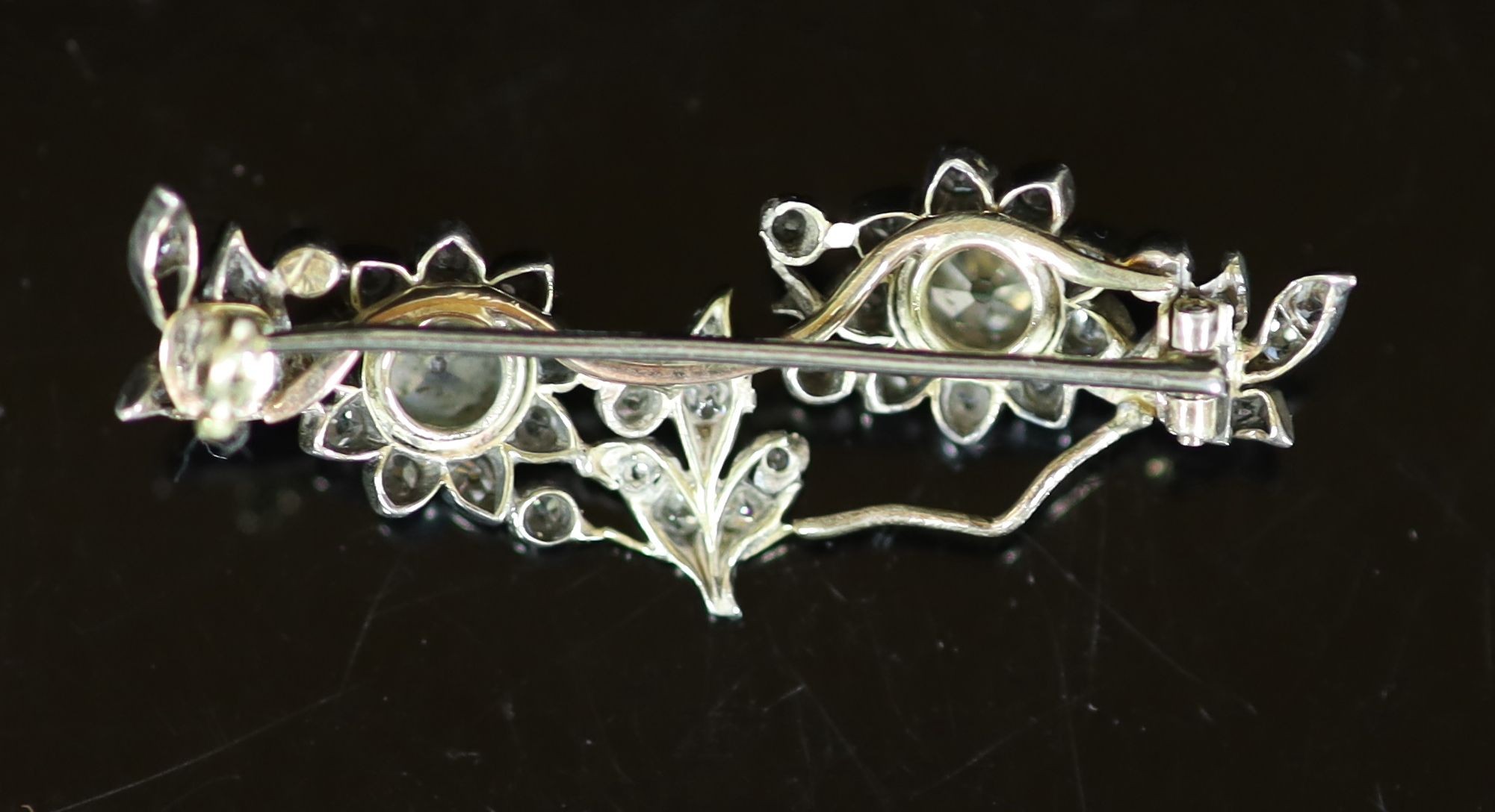 A late Victorian gold, silver and diamond cluster set foliate brooch